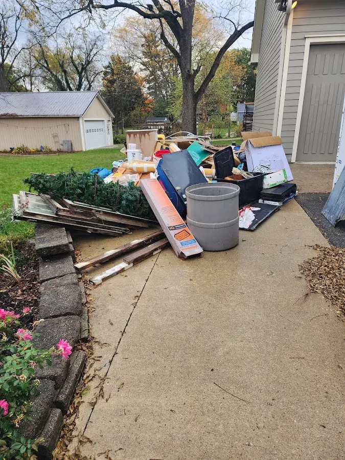 Dumpster being loaded with debris for 12 Yard Dumpster Rental in Kenneth City